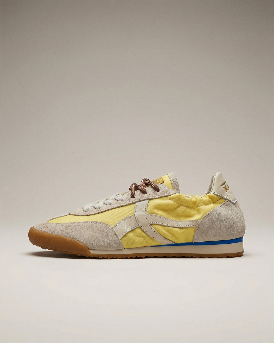 Sneaker with yellow and beige design on a neutral background