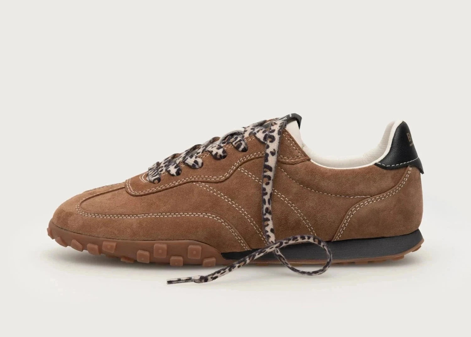 Brown leather sneaker with leopard print laces on a white background